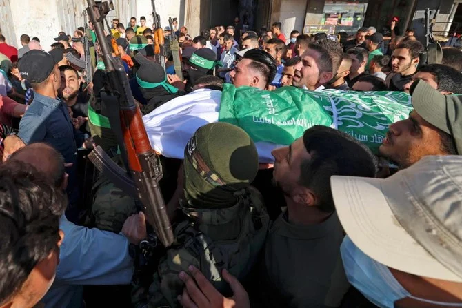 Palestinian members of Al-Qassam Brigades carry the body of one of two fighters who died after reportedly dismantling a bomb dropped in Gaza by Israeli forces, who said they arrested a Hamas leader in the West Bank. (AFP) Palestinian members of Al-Qassam Brigades carry the body of one of two fighters who died after reportedly dismantling a bomb dropped in Gaza by Israeli forces, who said they arrested a Hamas leader in the West Bank. (AFP)