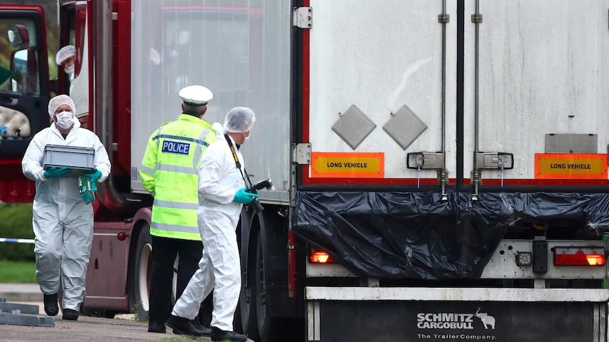 Police at the scene where bodies were discovered in the back of a truck in Essex.(Reuters Police at the scene where bodies were discovered in the back of a truck in Essex.(Reuters