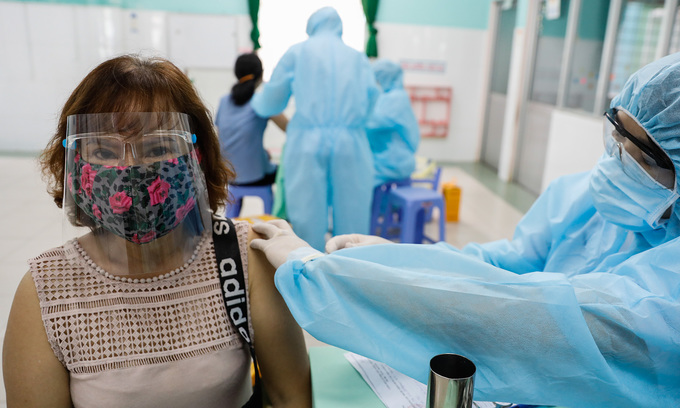 A woman receives a Covid-19 vaccine shot in HCMC, June 21, 2021. Photo by VnExpress/Huu Khoa. A woman receives a Covid-19 vaccine shot in HCMC, June 21, 2021. Photo by VnExpress/Huu Khoa.