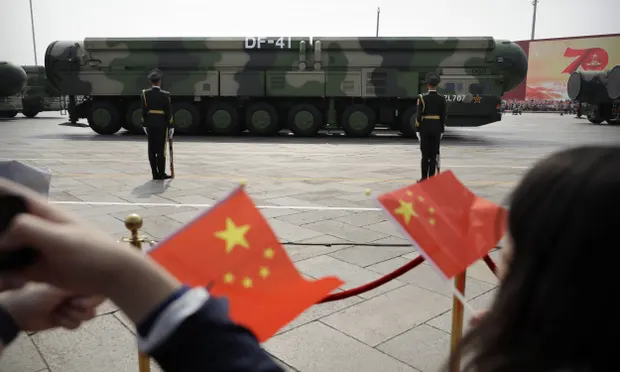 Chinese military vehicles carrying DF-41 ballistic missiles drive past flag-waving spectators during a parade in Beijing. Photograph: AP Chinese military vehicles carrying DF-41 ballistic missiles drive past flag-waving spectators during a parade in Beijing. Photograph: AP