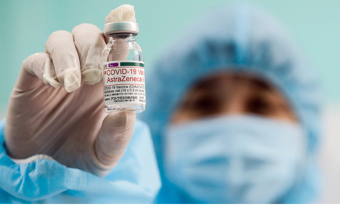 A medical worker holds up a vial containing the AstraZeneca Covid-19 vaccine in HCMC. Photo by VnExpress/Huu Khoa. A medical worker holds up a vial containing the AstraZeneca Covid-19 vaccine in HCMC. Photo by VnExpress/Huu Khoa.