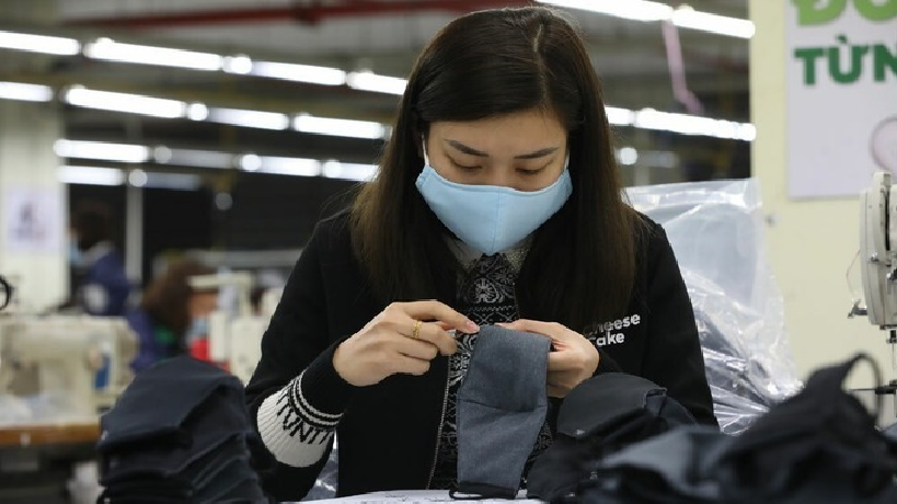 A worker manufactures face masks at a factory in Hanoi. Photo by VnExpress/Ngoc Thanh. 3756 face mask workers