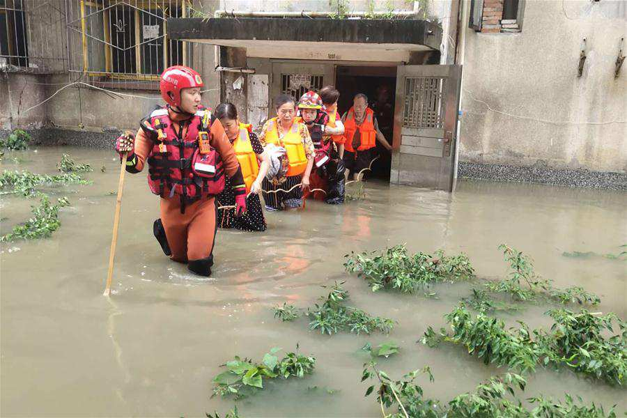 Rescuers help evacuate trapped people in Guanghan City, southwest China's Sichuan Province, Aug. 12, 2020. 0336 rescuers