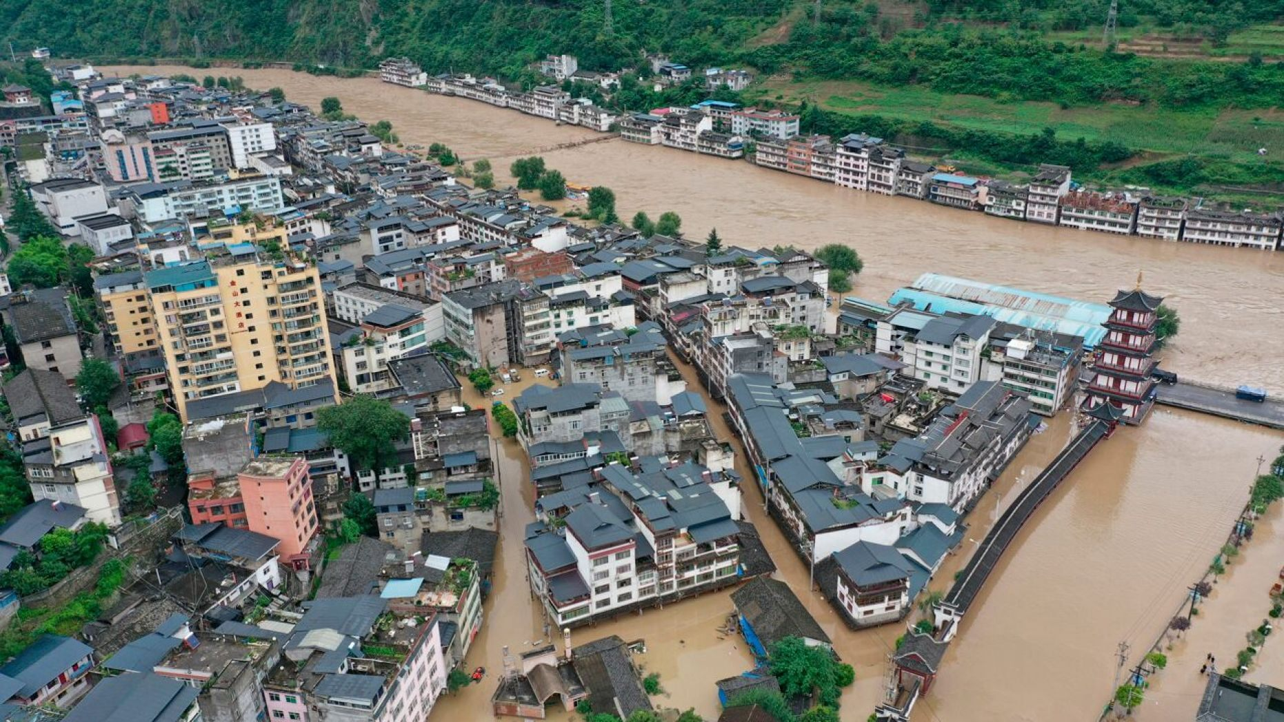 In this aerial photo released by China's Xinhua News Agency, flooding is seen in Bikou township of Longnan city in northwestern China's Gansu Province, Tuesday, Aug. 18, 2020. (Du Zheyu/Xinhua via AP) 1438 flood