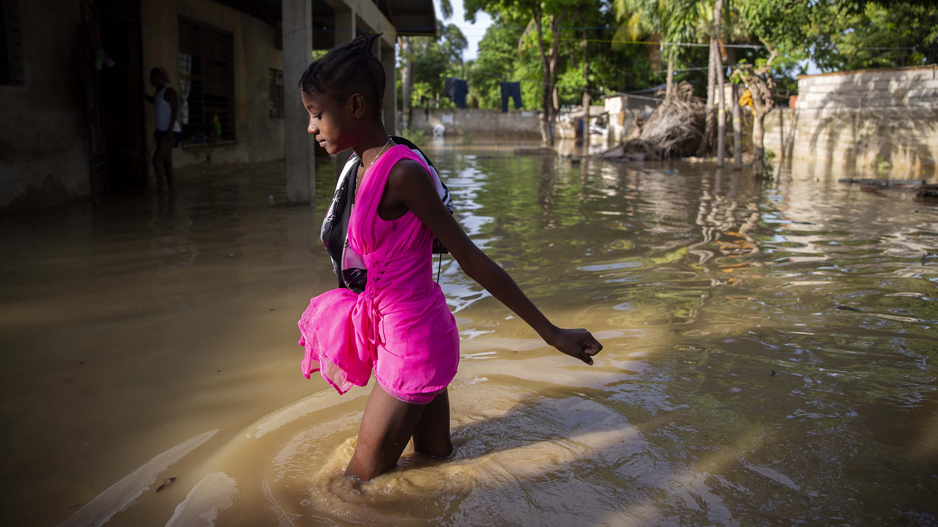 A girl wades towards her flooded home the day after the passing of Tropical Storm Laura in Port-au-Prince, Haiti, on Monday. 3837 laura 5