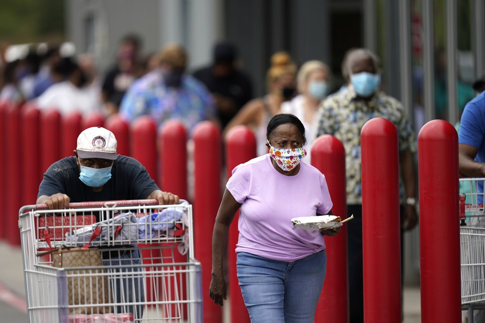 People line up to enter retail chain Costco to buy provisions in New Orleans, Sunday, Aug. 23, 2020, in advance of Hurricane Marco, expected to make landfall on the Southern Louisiana coast. (AP Photo/Gerald Herbert) 5136 laura 9