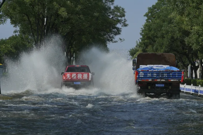 A truck with a banner which reads Delta Variant, Flooding Bearing Down China