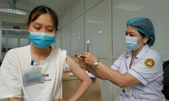 A woman receives a shot of the Nanocovax vaccine during a human trial phase in Hanoi, June 2021. Photo by VnExpress A woman receives a shot of the Nanocovax vaccine during a human trial phase in Hanoi, June 2021. Photo by VnExpress