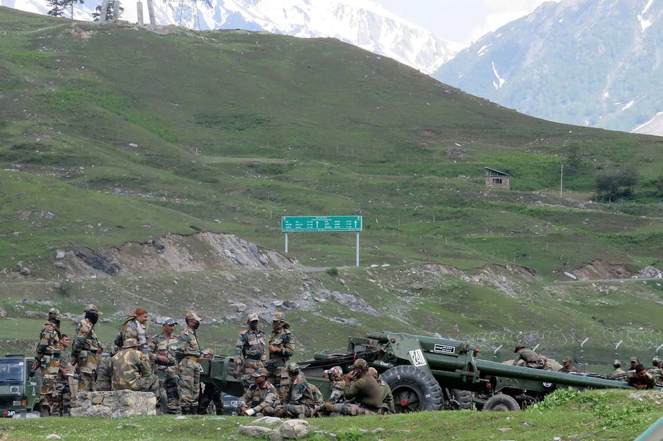 Indian Army soldiers rest next to artillery guns at a transit camp near Baltal, southeast of Srinagar, June 16, 2020 before heading to Ladakh. | Photo Credit: Reuters 2801 troops