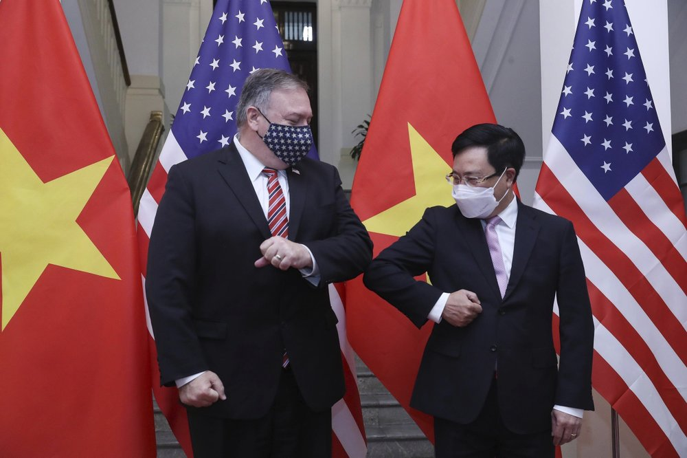 U.S. Secretary of State Mike Pompeo, left, and Vietnamese Foreign Minister Pham Binh Minh gesture with their elbows before a meeting in Hanoi, Vietnam, Friday, Oct. 30, 2020. Pompeo is wrapping up an anti-China tour of Asia in Vietnam as the fierce American presidential election race enters its final stretch. (Bui Lam Khanh/VNA via AP) 2855 peompeo q