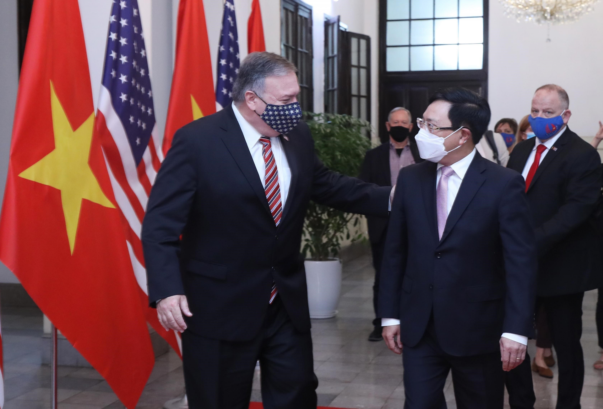 U.S. Secretary of State Mike Pompeo, left, and Vietnamese Foreign Minister Pham Binh Minh walk for a meeting in Hanoi, Vietnam, Friday, Oct. 30, 2020. Pompeo is wrapping up an anti-China tour of Asia in Vietnam as the fierce American presidential election race enters its final stretch. (Bui Lam Khanh/VNA via AP) 3521 minh