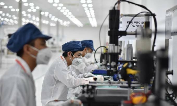 Employees work at a smartphone factory in Hai Phong City, northern Vietnam. Photo by VnExpress Employees work at a smartphone factory in Hai Phong City, northern Vietnam. Photo by VnExpress