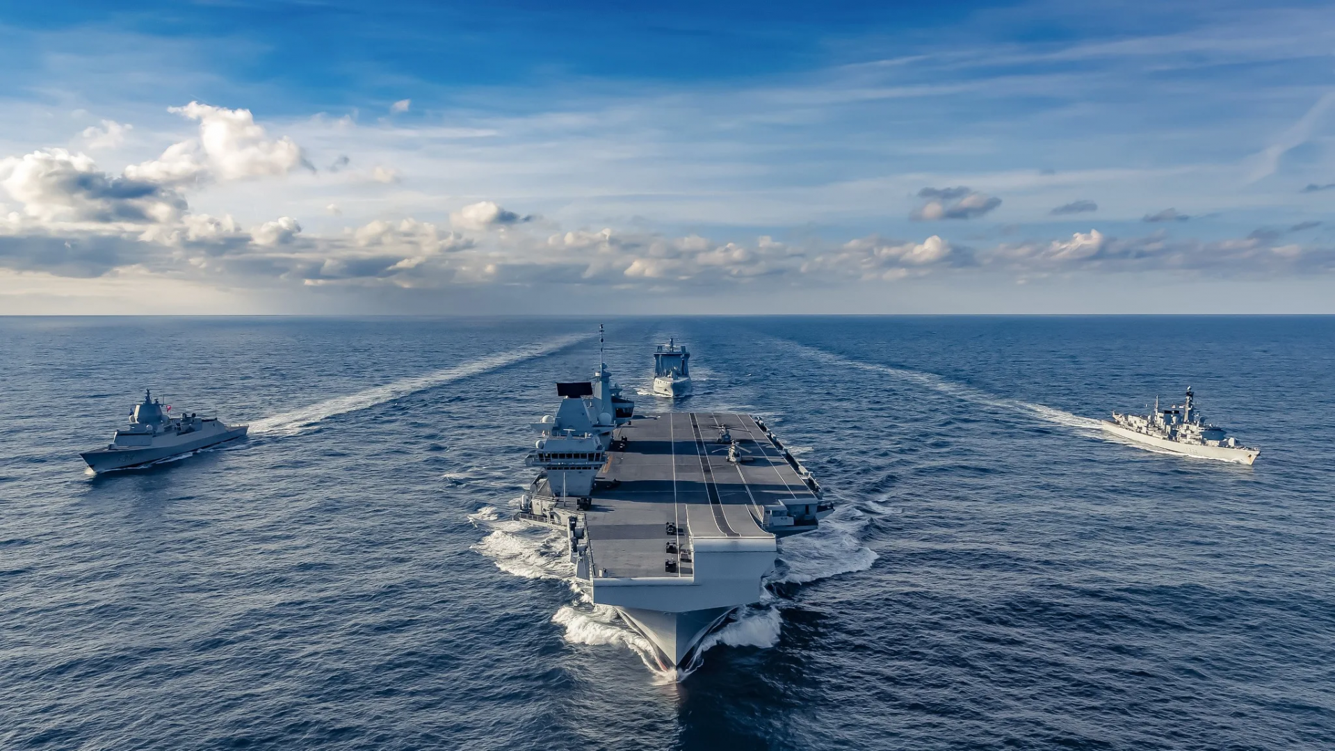 The British aircraft carrier HMS Queen Elizabeth, center, shown here in an Atlantic transit, will head to the Indo-Pacific region for exercises with the U.S. and Japan, Kyodo reports. (Photo courtesy of the Royal Navy) 3018 carrier