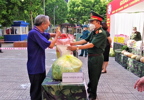 ການນໍາກອງບັນຊາການທະຫານນະຄອນຫຼວງຮ່າໂນ້ຍ ມອບເຄື່ອງໃຊ້ທີ່ຈໍາເປັນໃຫ້ແກ່ປະຊາຊົນທີ່ປະສົບຄວາມຫຍຸ້ງຍາກຢູ່ເມືອງນາມຕືລຽມ. ພາບ: qdnd.vn.