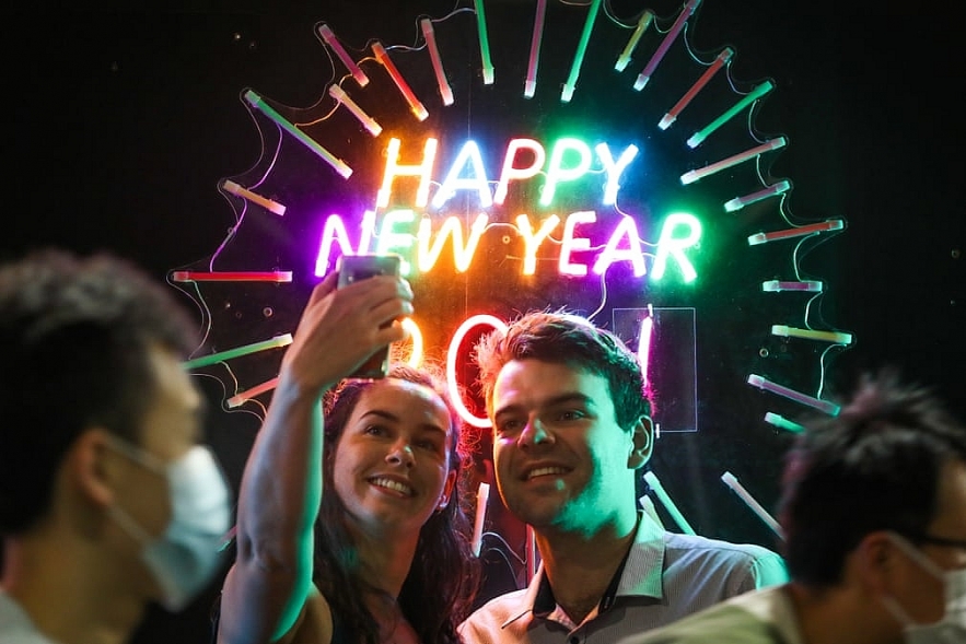 Masked pedestrians pass a celebrating couple in Melbourne, Australia Photograph: Asanka Ratnayake/Getty Images FacebookTwitterPinterest 1602 ny 4