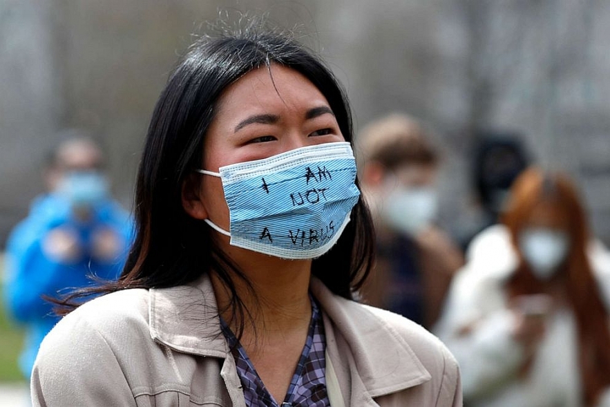 A demonstrator wearing a mask saying Asian American attacks: Rallies, protesters against racially motivated violence witness widespread participation