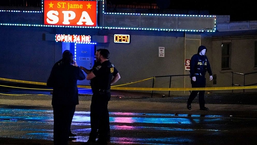 Law enforcement officials gather outside a spa following a shooting, March 16, 2021, in Atlanta. Brynn Anderson/AP. 2608-spa