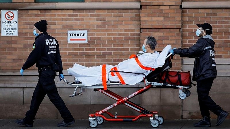 Paramedics taking a patient into an emergency centre at Maimonides Medical Center in the Brooklyn borough of New York, United States. Photo: Andrew Kelly/Reuters 0930 covid us 1
