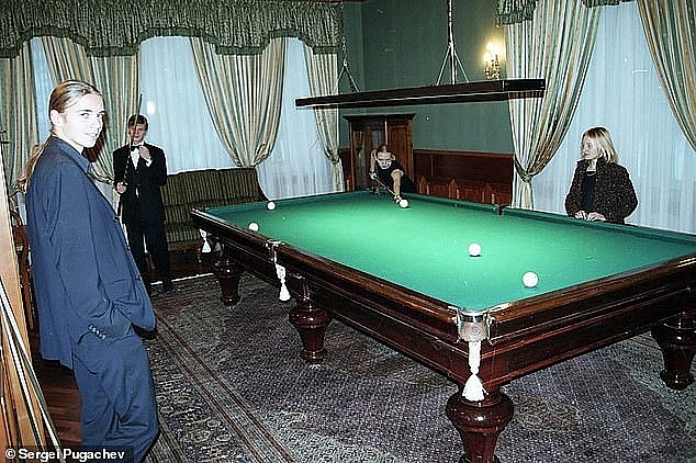 Ekaterina (right) watches as her sister Maria plays pool with Sergei Pugachev's son Alexander (second from left) and Viktor (left) in the Kremlin in the early 2000s. Photo: Daily Mail 5553 putin daughter 1