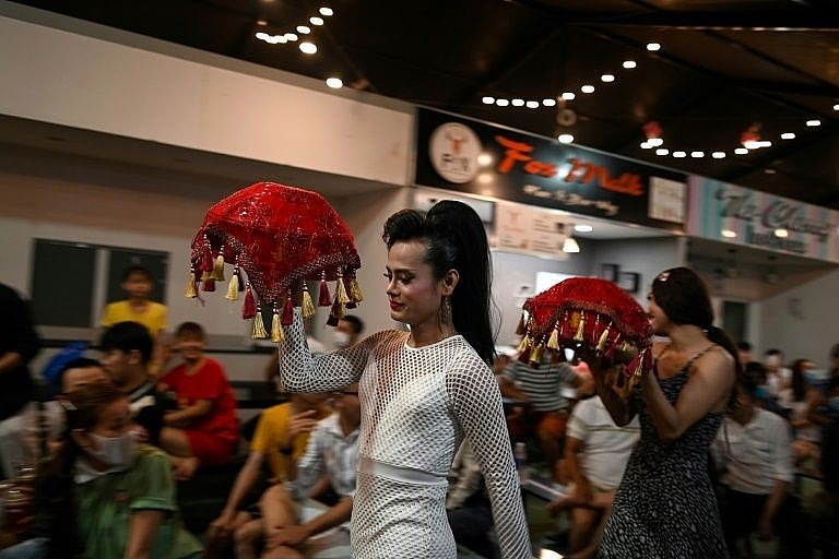 A traditional Vietnamese ao dai dress worn by a member of the Sai Gon Tan Thoi LGBT lotto troupe. Photo: AFP 0357 lgbt vietnam 7
