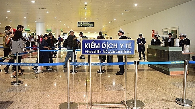 Passengers go through the health quarantine area at Hanoi's Noi Bai Airport. Photo Credit: VnExpress/Giang Huy 4418 du ich vietnam