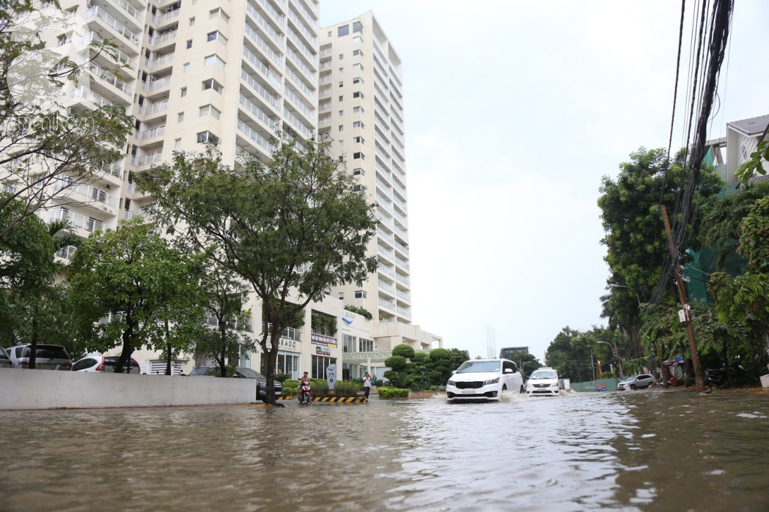 khu biet thu o sai gon ngap nang sau mua tre em truong quoc te duoc bo me cong tren vai loi nuoc ve nha