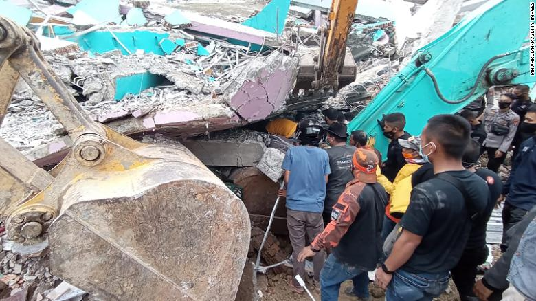 Rescuers search for survivors at a collapsed building in Mamuju city in Indonesia. 3434 indo1