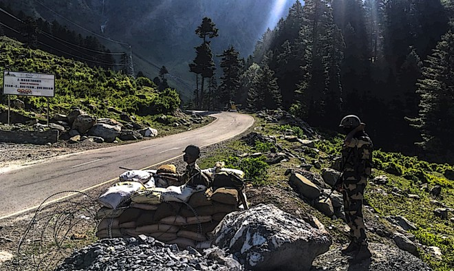 Indian border guards stand guard on the road towards the disputed Ladakh border area AFP 0422 china
