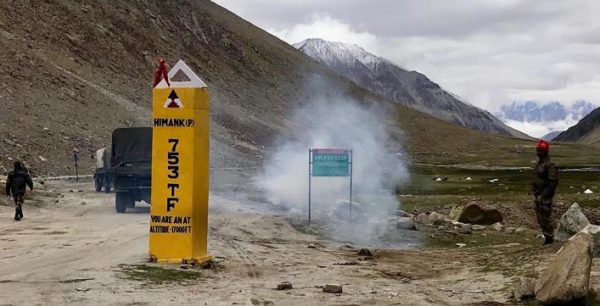 Exhaust from an army truck covers engulfs an environmentalist sign. Photo by Ruth Gamble. 0729 chiin1