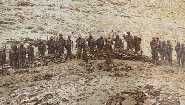 Armed with spears: Chinese troops near the disputed Himalayan border with India this week where gunfire is banned but soldiers fought in deadly hand-to-hand combat in June 1309 in2