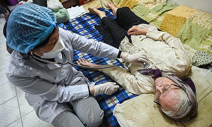 A Hanoi woman has her health checked before Covid-19 vaccination, January 2022. Photo: VnExpress A Hanoi woman has her health checked before Covid-19 vaccination, January 2022. Photo: VnExpress
