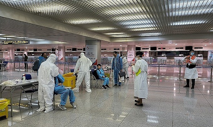 Medical staff take samples of foreign arrivals at Tan Son Nhat Airport in HCMC, January 2022. Photo: HCMC's Center for Disease Control Medical staff take samples of foreign arrivals at Tan Son Nhat Airport in HCMC, January 2022. Photo: HCMC's Center for Disease Control