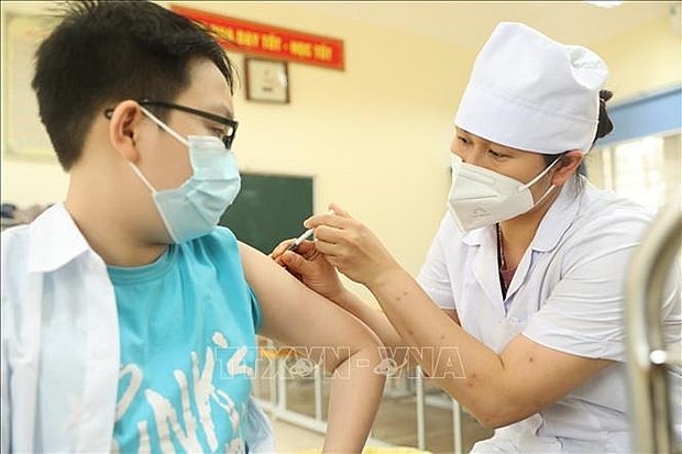 Health worker gives a COVID-19 vaccine jab for a child. Photo: VNA Health worker gives a COVID-19 vaccine jab for a child. Photo: VNA