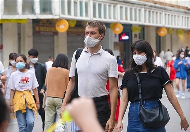 Foreigners stroll the pedestrian zone around Hoan Kiem Lake. Photo: VNA
