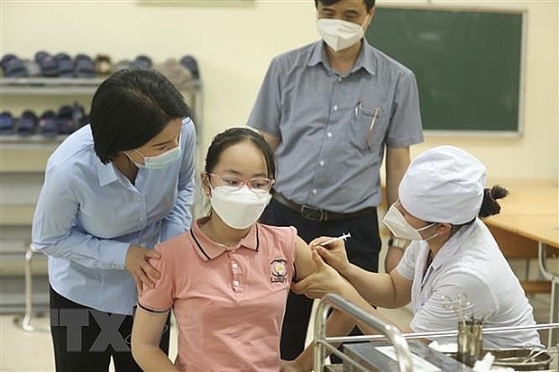 A student gets vaccinated against Covid-19. Photo: VNA A student gets vaccinated against Covid-19. Photo: VNA
