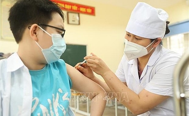 A boy gets vaccinated against Covid-19. Photo: VNA A boy gets vaccinated against Covid-19. Photo: VNA