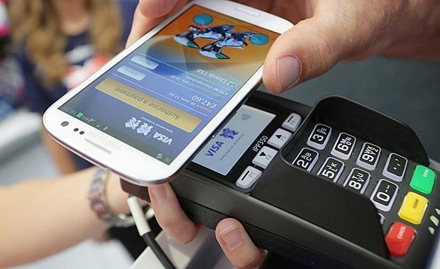 A type of cashless payment. Photo: VNA A type of cashless payment. Photo: VNA