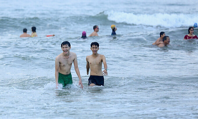 People swim at a beach in Da Nang City, July 10, 2021. Photo: VnExpress People swim at a beach in Da Nang City, July 10, 2021. Photo: VnExpress