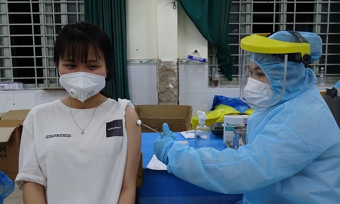 A woman gets Covid-19 vaccine in HCMC, August 5, 2021. Photo: VnExpress A woman gets Covid-19 vaccine in HCMC, August 5, 2021. Photo: VnExpress