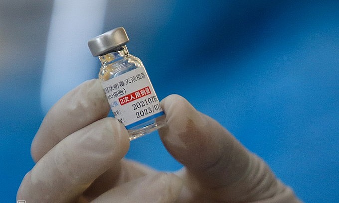 A health worker holds a vial containing a Covid-19 vaccine by Sinopharm in HCMC's Thu Duc City, August 15, 2021. Photo: VnExpress A health worker holds a vial containing a Covid-19 vaccine by Sinopharm in HCMC's Thu Duc City, August 15, 2021. Photo: VnExpress
