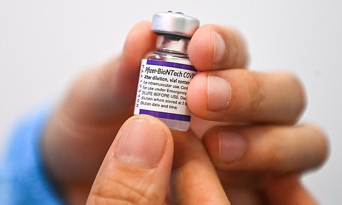 A medical staff holds a Covid-19 vaccine container in Hanoi, September 11, 2021. Photo: VnExpress A medical staff holds a Covid-19 vaccine container in Hanoi, September 11, 2021. Photo: VnExpress