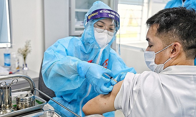 A man receives a Covid-19 vaccine shot in Hanoi, March 8, 2021. Photo: VnExpress A man receives a Covid-19 vaccine shot in Hanoi, March 8, 2021. Photo: VnExpress