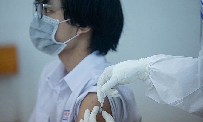 A student receives a Covid-19 vaccine shot in HCMC's District 1, October 27, 2021. Photo: VnExpress A student receives a Covid-19 vaccine shot in HCMC's District 1, October 27, 2021. Photo: VnExpress