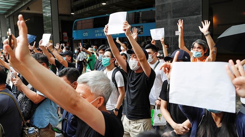 Supporters raise white paper to avoid slogans banned under the national security law as they support arrested anti-law protesters in Hong Kong . Photo: Tyrone Siu/Reuters 4903 7d7c7ebb0d9540729c9a6a95d7945520 18