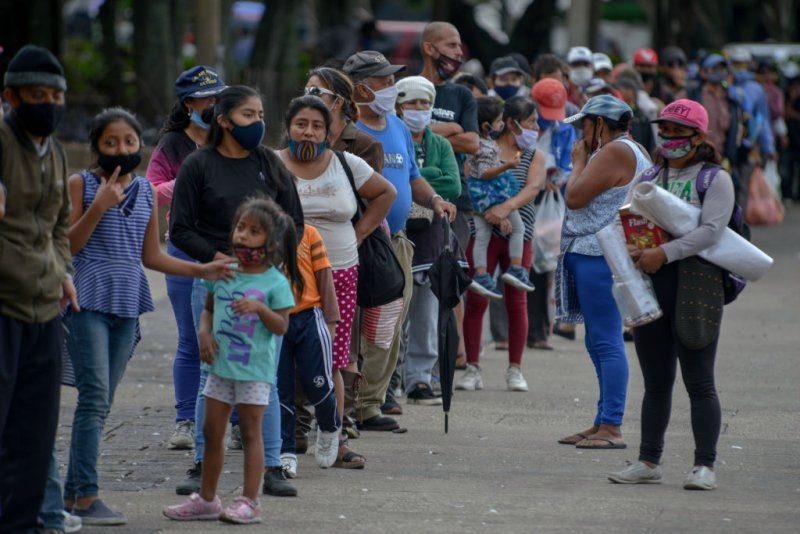 Hundreds of Guatemalans line up on July 2nd in the central square in Guatemala City, Guatemala for the food delivery. The youth collective ''olla comunitaria'' during the pandemic receives a donation for the preparation of food during the pandemic that affects the country. Deccio Serrano—Getty 3221 food distribution line