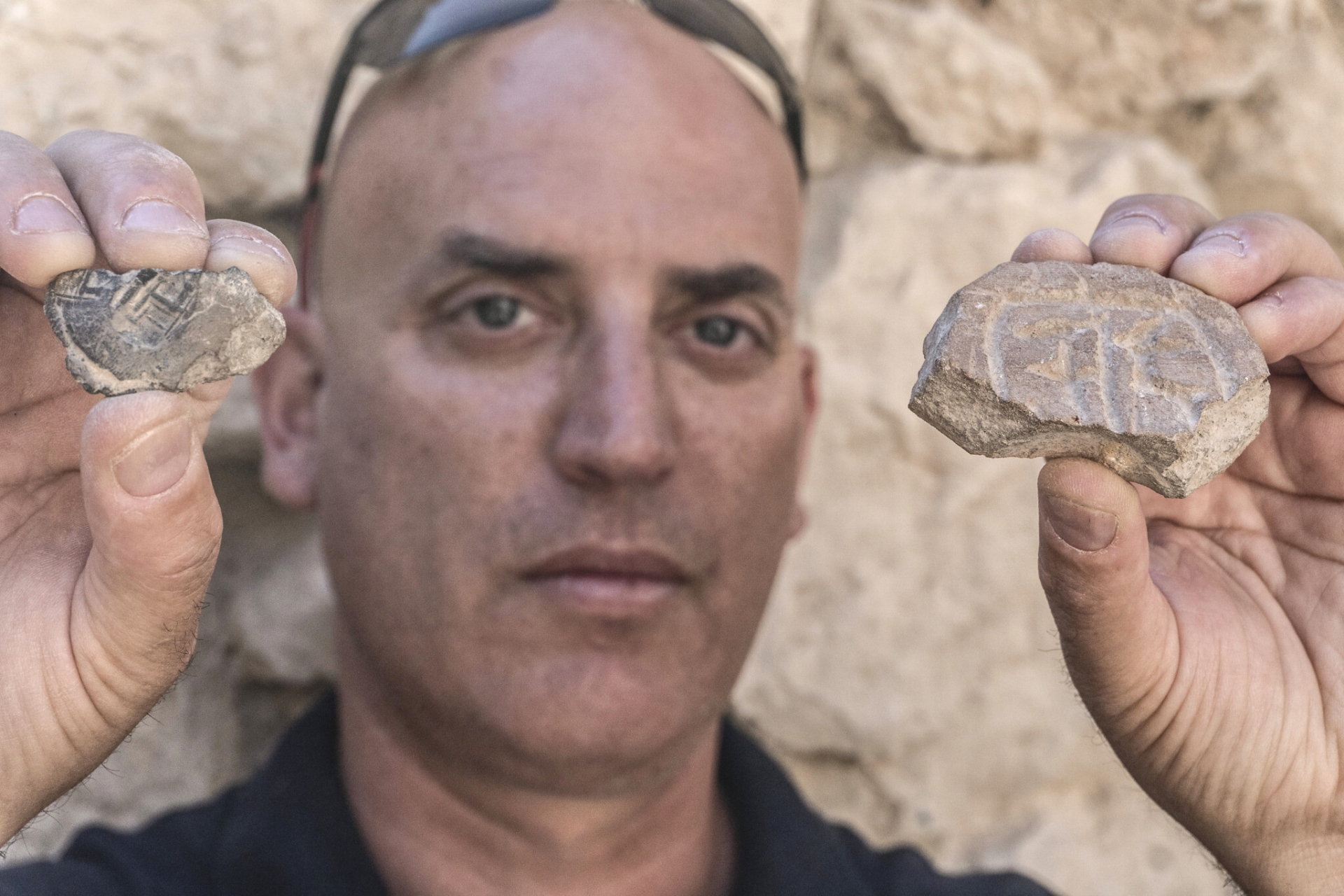Israel Antiquities Authority’s Dr. Yiftah Shalev with the Persian-era seal and seal impression discovered in the City of David’s Givati Parking Lot excavations. (Shai Halevy, Israel Antiquities Authority) 5314 israel seal impression