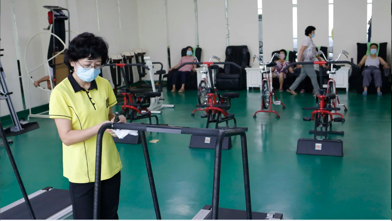 An employee disinfects a treadmill at the Ryugyong Health Complex in Pyongyang, North Korea. Photo: AP 3641 capture
