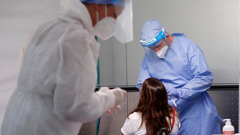 medical workers wearing protective gear collect swabs from a passenger arriving from one of four Mediterranean countries. - Copyright AP Photo/Antonio Calanni 5939 773x435 cmsv2 1edcc723 6c1f 5f9a 85db 295fc54c1648 4901880